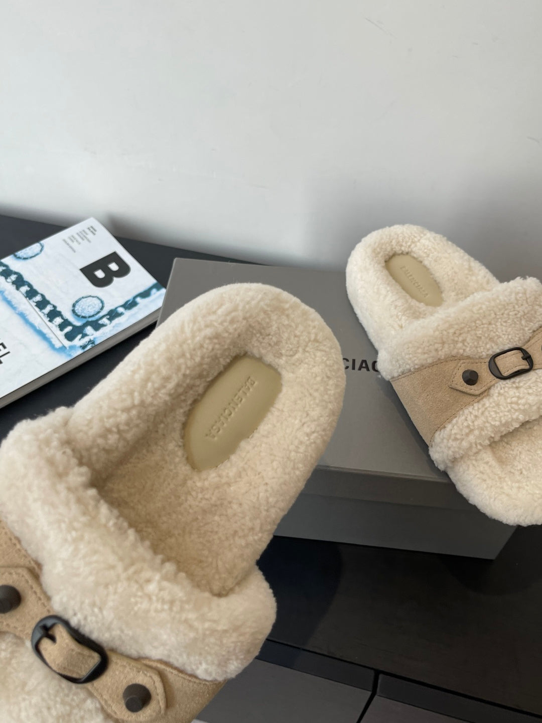 Beige faux shearling slide sandals, close-up of strap and metal buckle