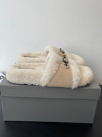 Shearling slide sandals with wide strap and metal buckle detail, beige