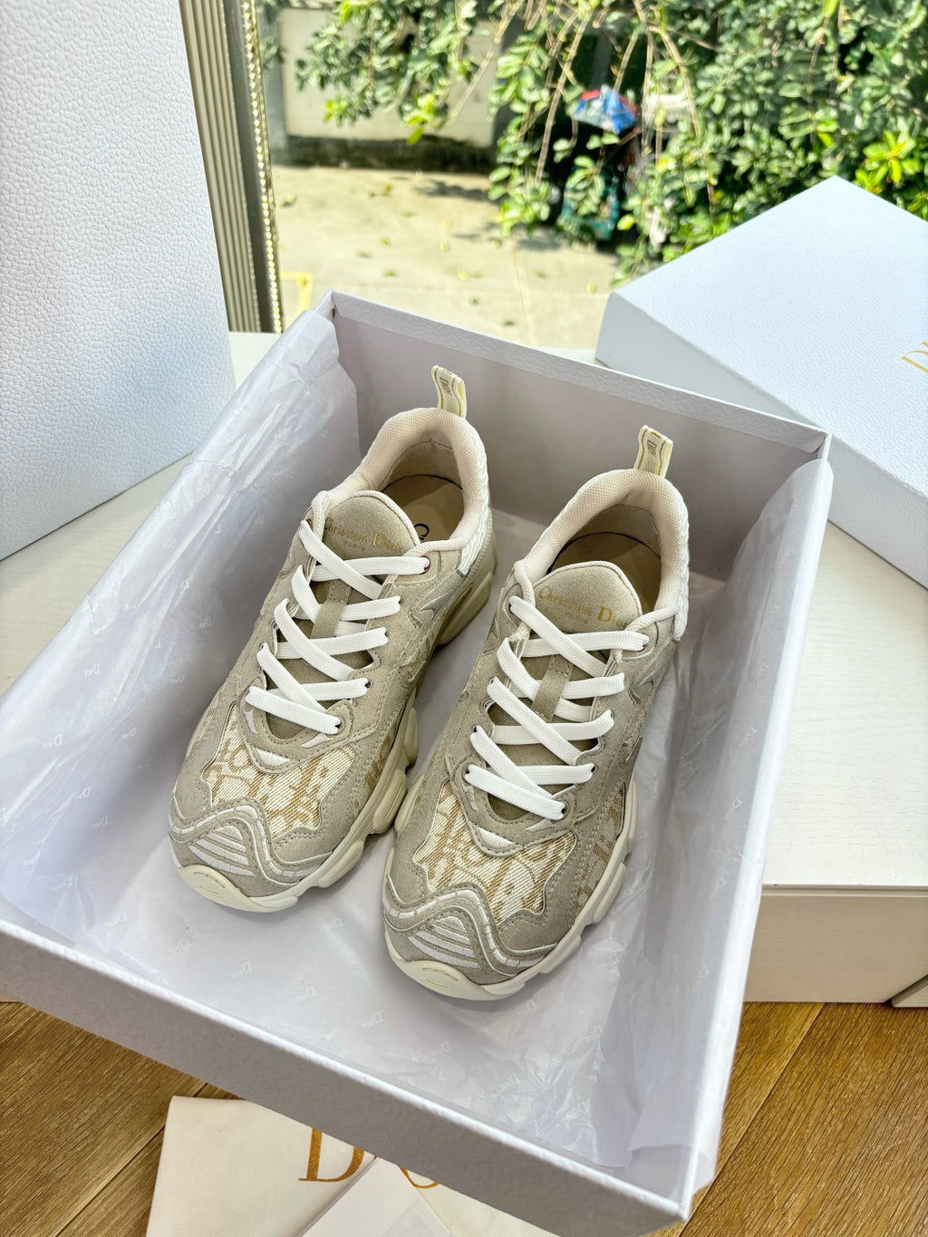 Tan lace-up sneakers with patterned panels and white laces