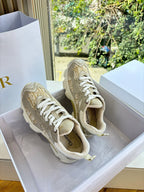 Tan lace-up sneakers with chunky sole and patterned side panels