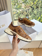 Brown and tan lace-up sneakers with white sole, mesh upper and stitched overlay