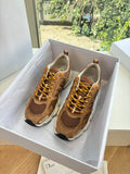 Brown lace-up sneakers with perforated toe and tan chunky sole