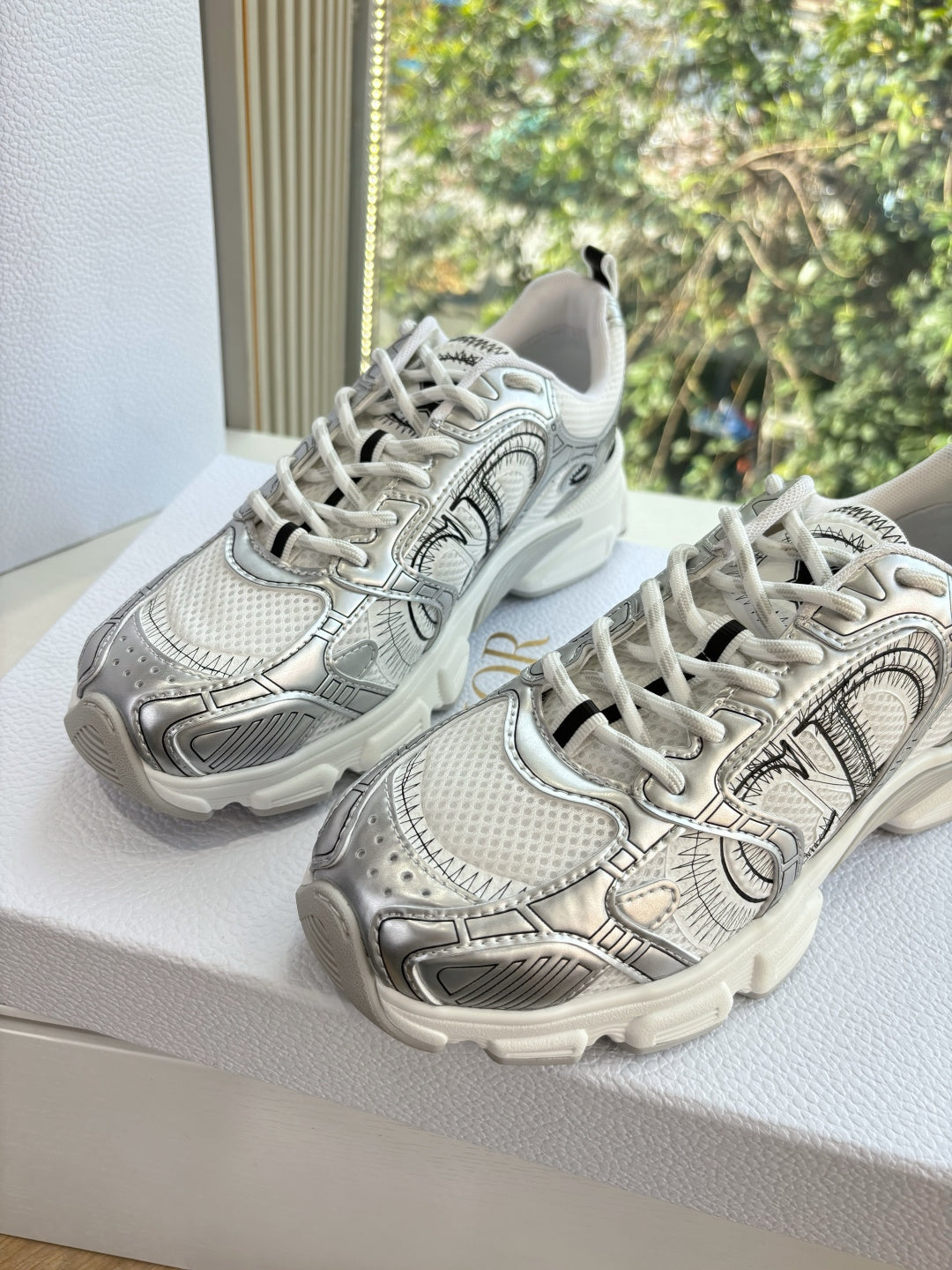Ladies' gray lace-up sneakers with sculpted sole and patterned overlay, side view