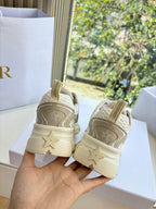 Beige lace-up sneakers with star logo on back heel and thick sole