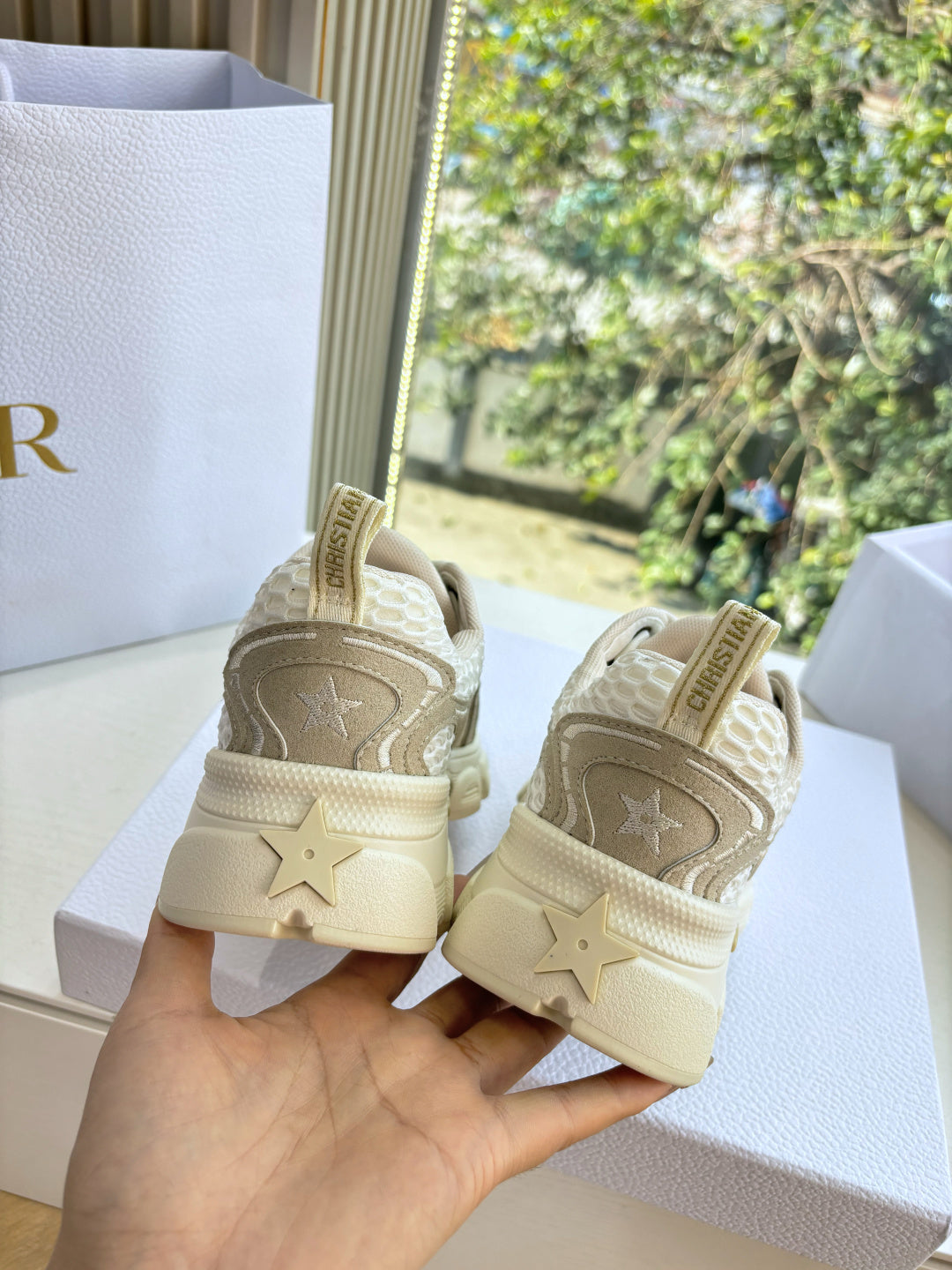 Beige lace-up sneakers with star logo on back heel and thick sole