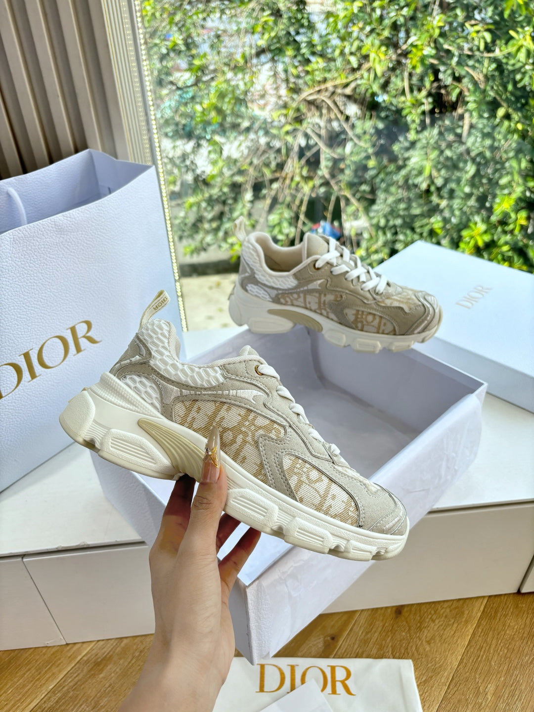 Beige lace-up sneakers with gold-patterned upper and rubber sole