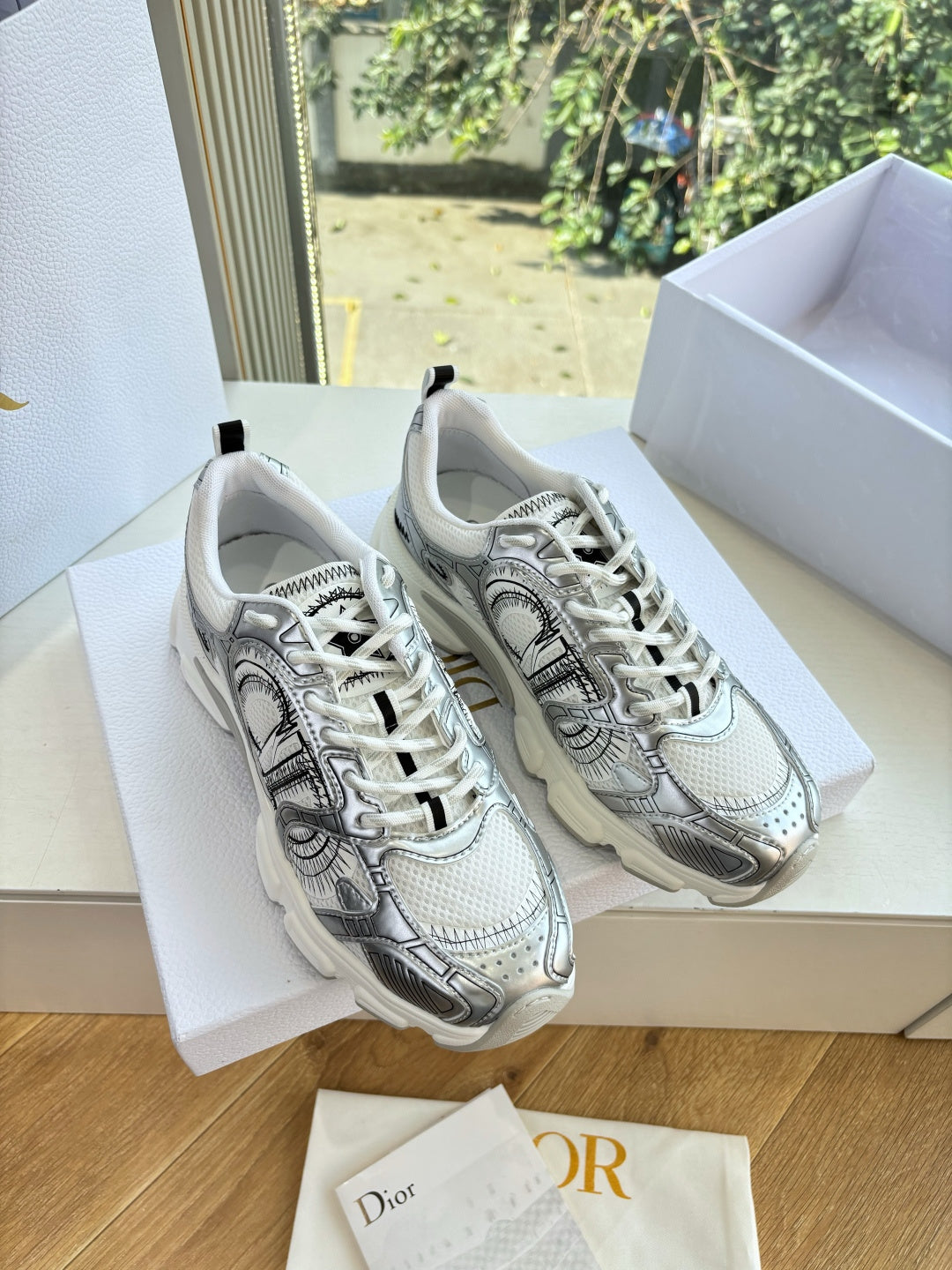 Ladies' gray lace-up sneakers with patterned design, displayed in a box