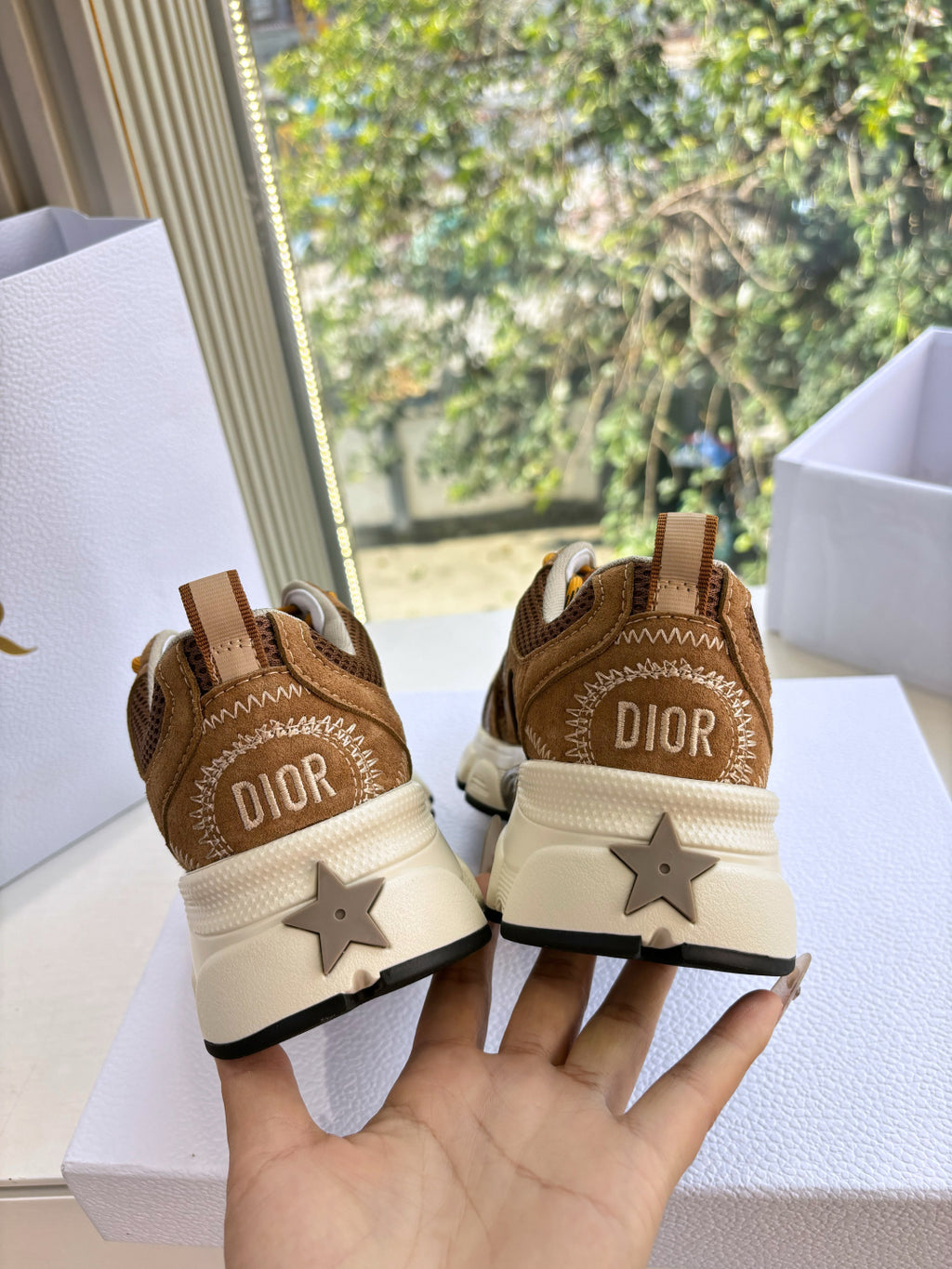 Brown sneakers heel view with DIOR detail and star logo on cream sole