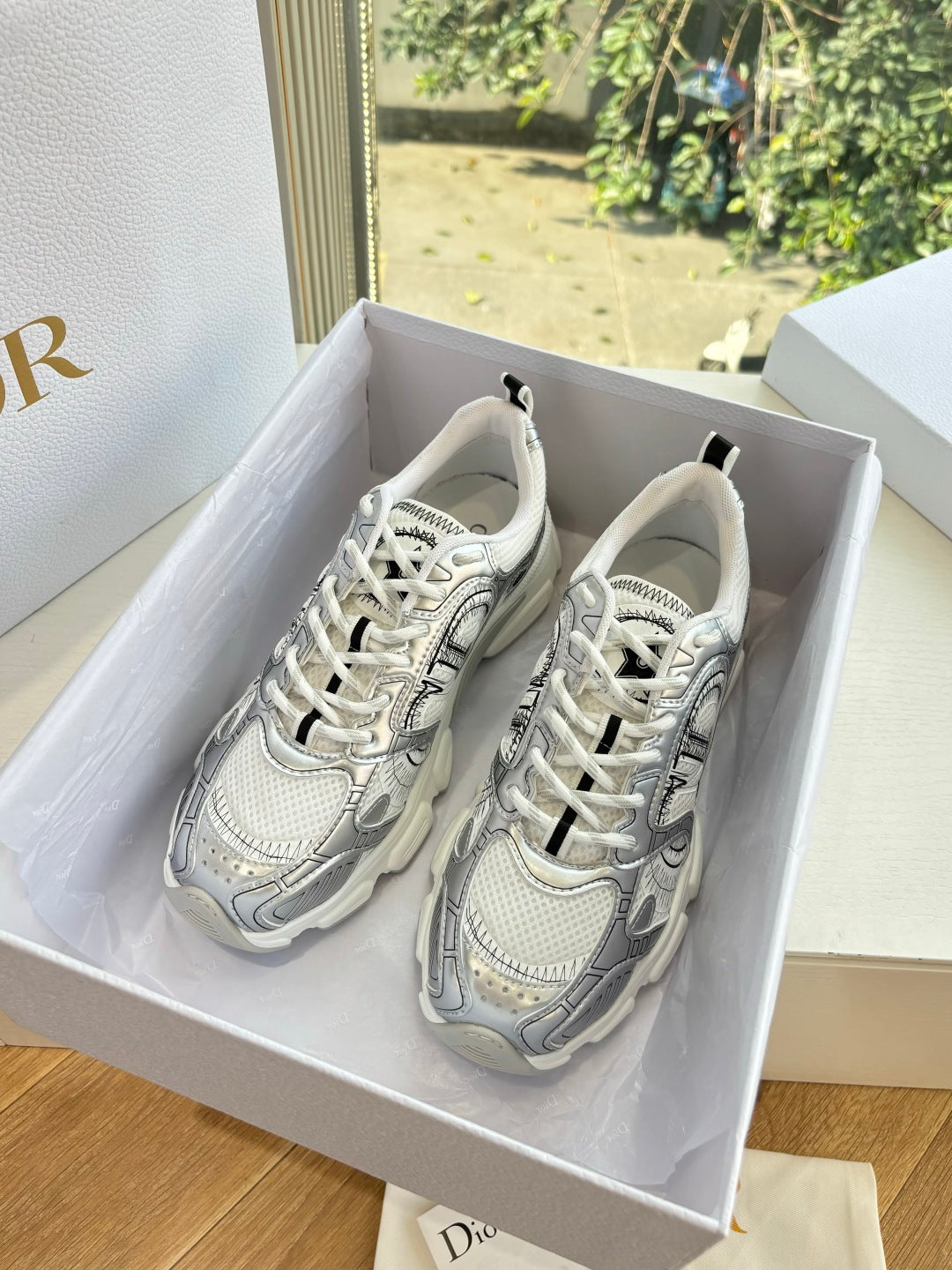 Ladies' gray lace-up sneakers with patterned paneling in a shoe box