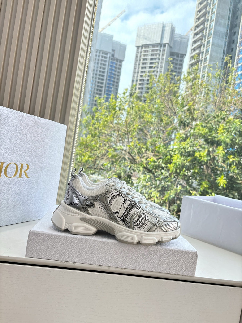 Ladies' gray lace-up sneaker on a box, with textured upper and thick sole