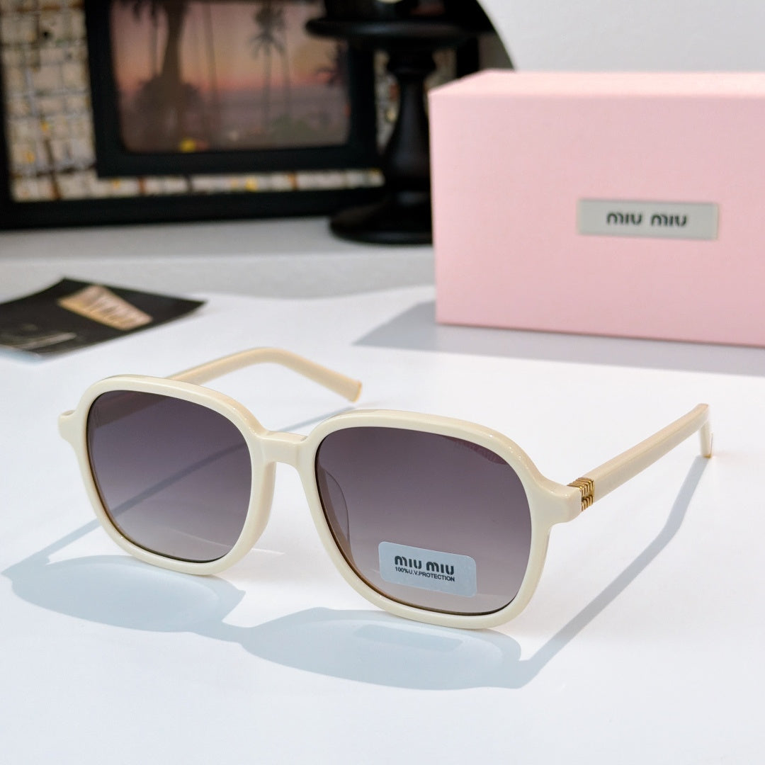 MiuMiu cream sunglasses with dark lenses and gold-tone hinges; logo on temple.