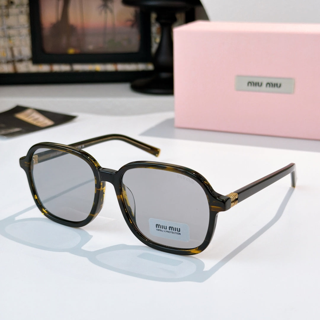 MiuMiu dark tortoise sunglasses with blue-tinted lenses and gold-tone hinges; logo on temple.