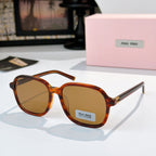 MiuMiu orange-brown tortoise sunglasses with amber lenses and gold-tone hinges; logo on lens.