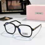 MiuMiu black sunglasses with blue-tinted lenses and gold-tone hinges; logo on temple.