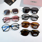 Assorted MiuMiu sunglasses in black, cream, pink, and tortoise frames with colored lenses.