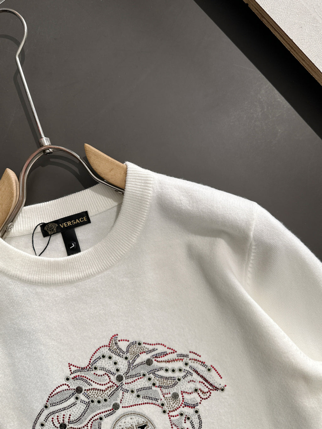 White Versace sweatshirt close-up of crew neck and rhinestone dog graphic