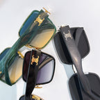 Celine sunglasses close-up: green mirrored lens pair and black mirrored lens pair.