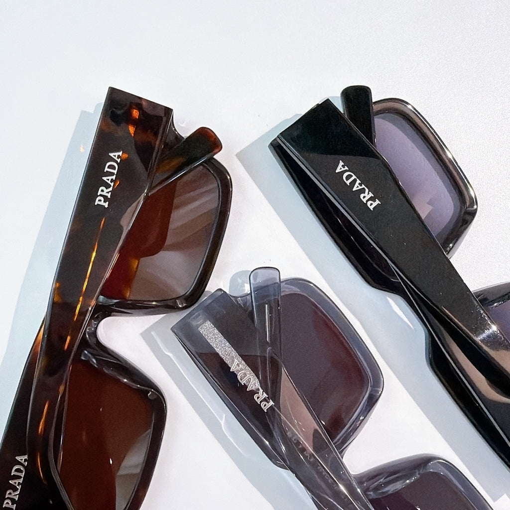 Prada sunglasses set with assorted frames and tinted lenses, close-up