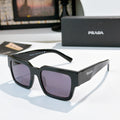 Prada sunglasses with dark frame and purple lenses, square cat-eye
