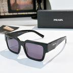 Prada sunglasses with dark frame and purple lenses, square cat-eye