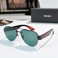 Aviator sunglasses with dark teal lenses and black frame, red logo temple detail