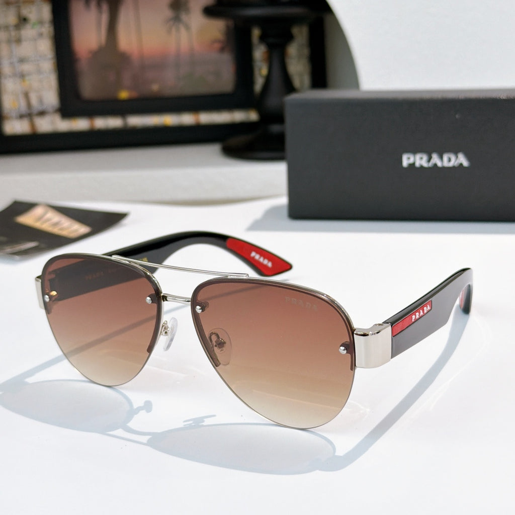 Aviator sunglasses with warm brown lenses, gold frame, and red logo temple detail
