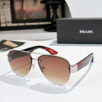 Aviator sunglasses with warm brown lenses, gold frame, and red logo temple detail