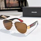 Aviator sunglasses with brown lenses and gold frame, red logo temple detail