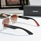 Aviator sunglasses with amber lenses and silver frame, black temple with red logo