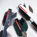 Prada sunglasses temples with red and white logo stripe on dark arms