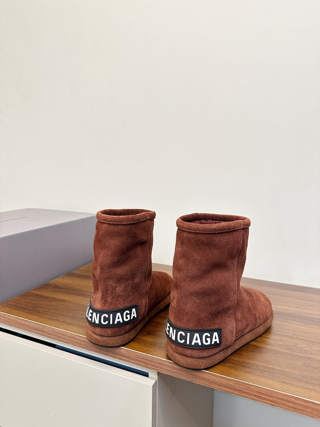 Brown suede ankle boots with Balenciaga logo printed on front cuffs, heel view