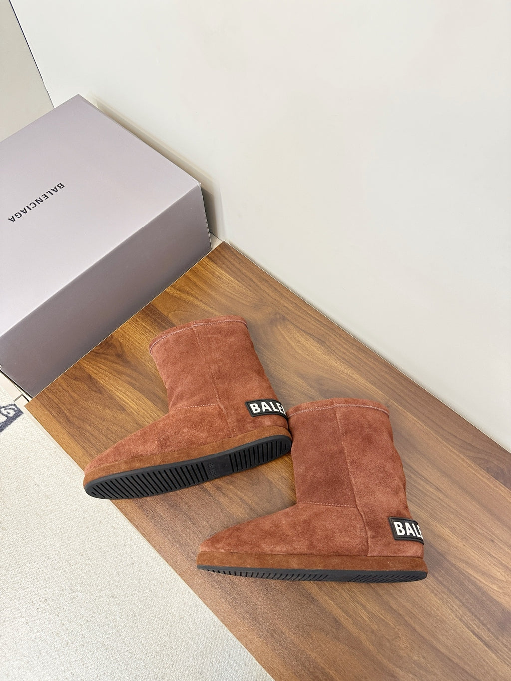 Brown suede ankle boots with black rubber soles, Balenciaga logo on heel tabs