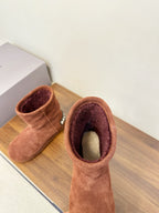 Brown suede ankle boots with interior lining visible, pair side view