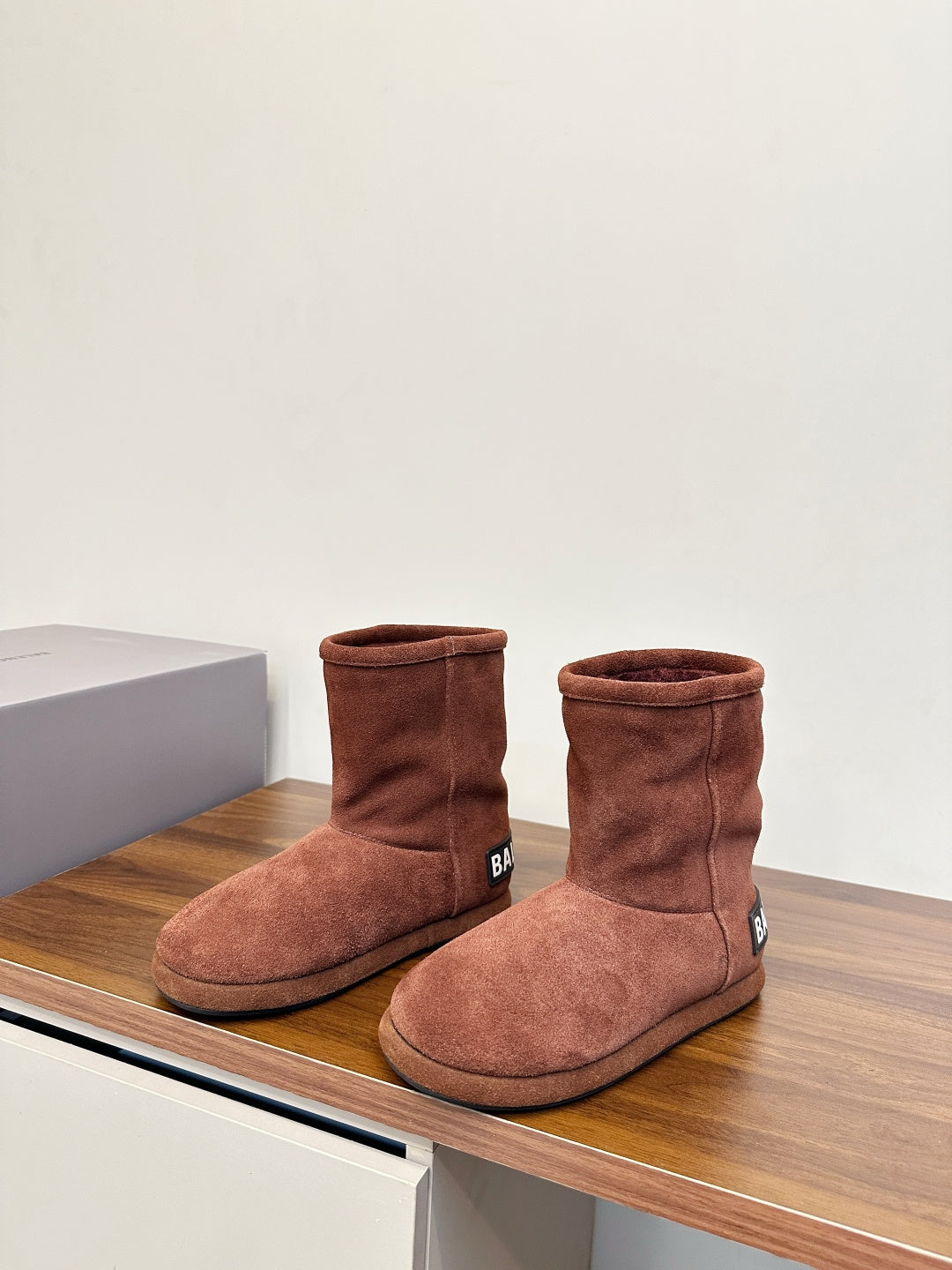 Brown suede ankle boots, standing pair with round toe and padded ankle collar