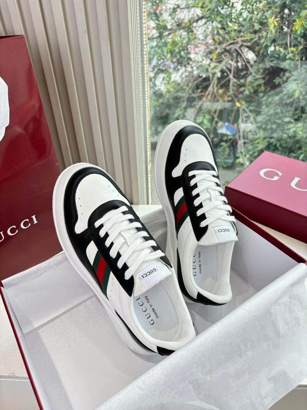 Gucci low-top sneakers, black-and-white design with green and red stripe details