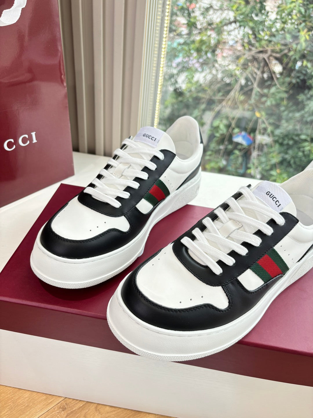 Gucci low-top sneakers, pair on box with white laces and black side panel stripe