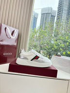 White Gucci leather sneaker on box with red and green side stripe and lace-up front