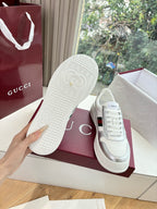 White Gucci sneaker outsole with textured tread pattern, held above box