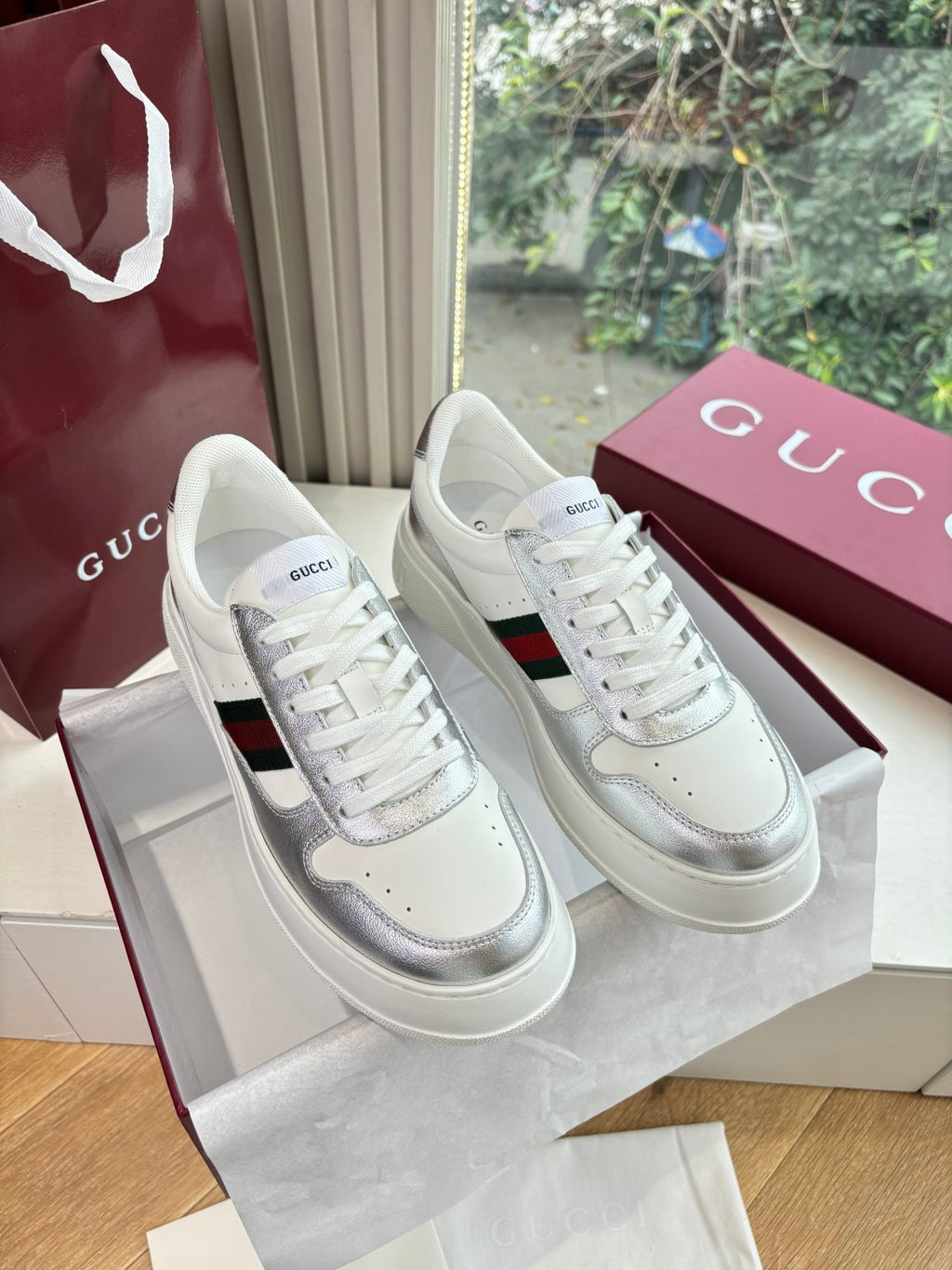 White Gucci leather sneakers with red and green side stripe, white laces, low profile