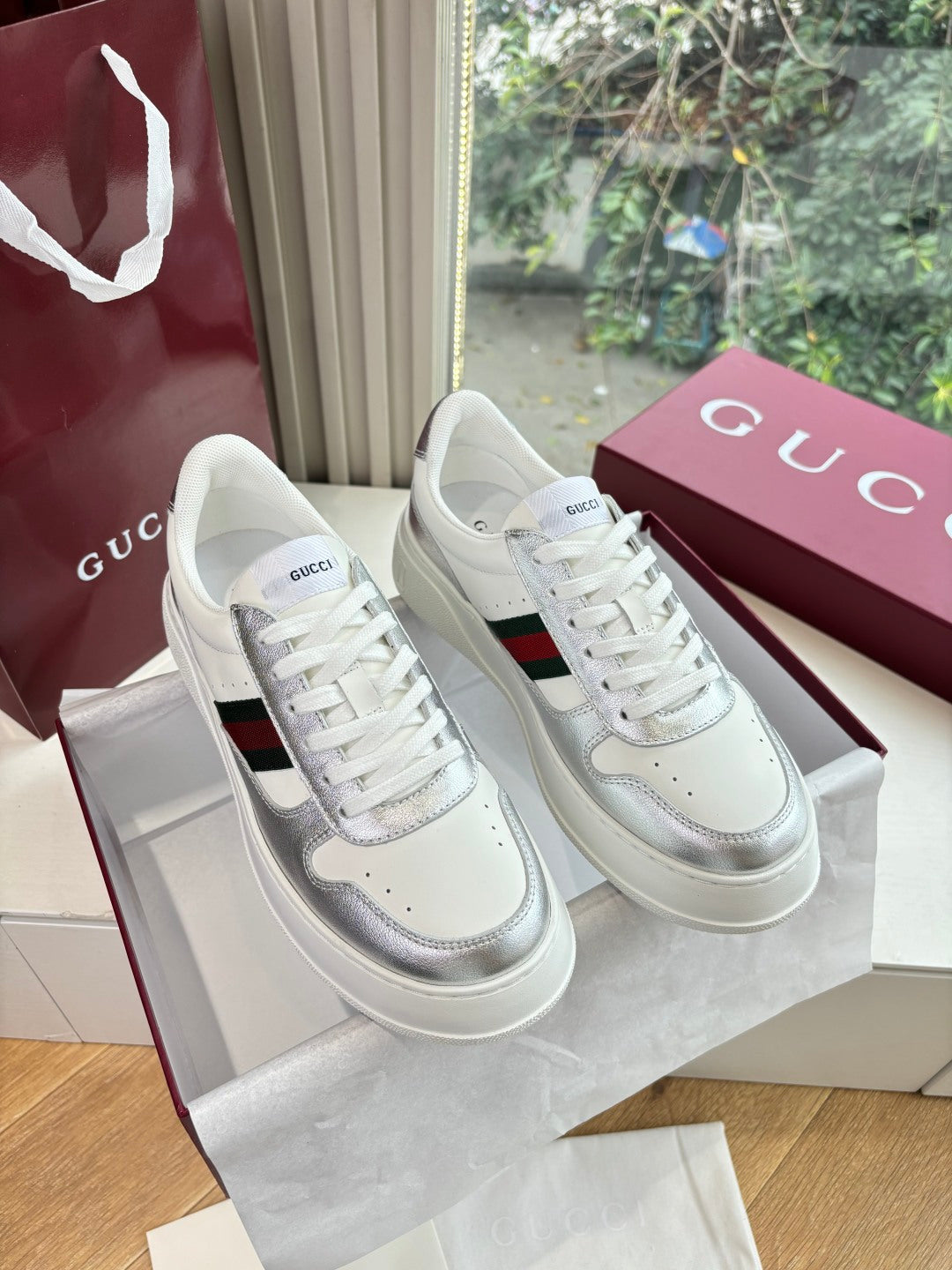 White Gucci leather sneakers with red and green side stripe, white laces, low profile