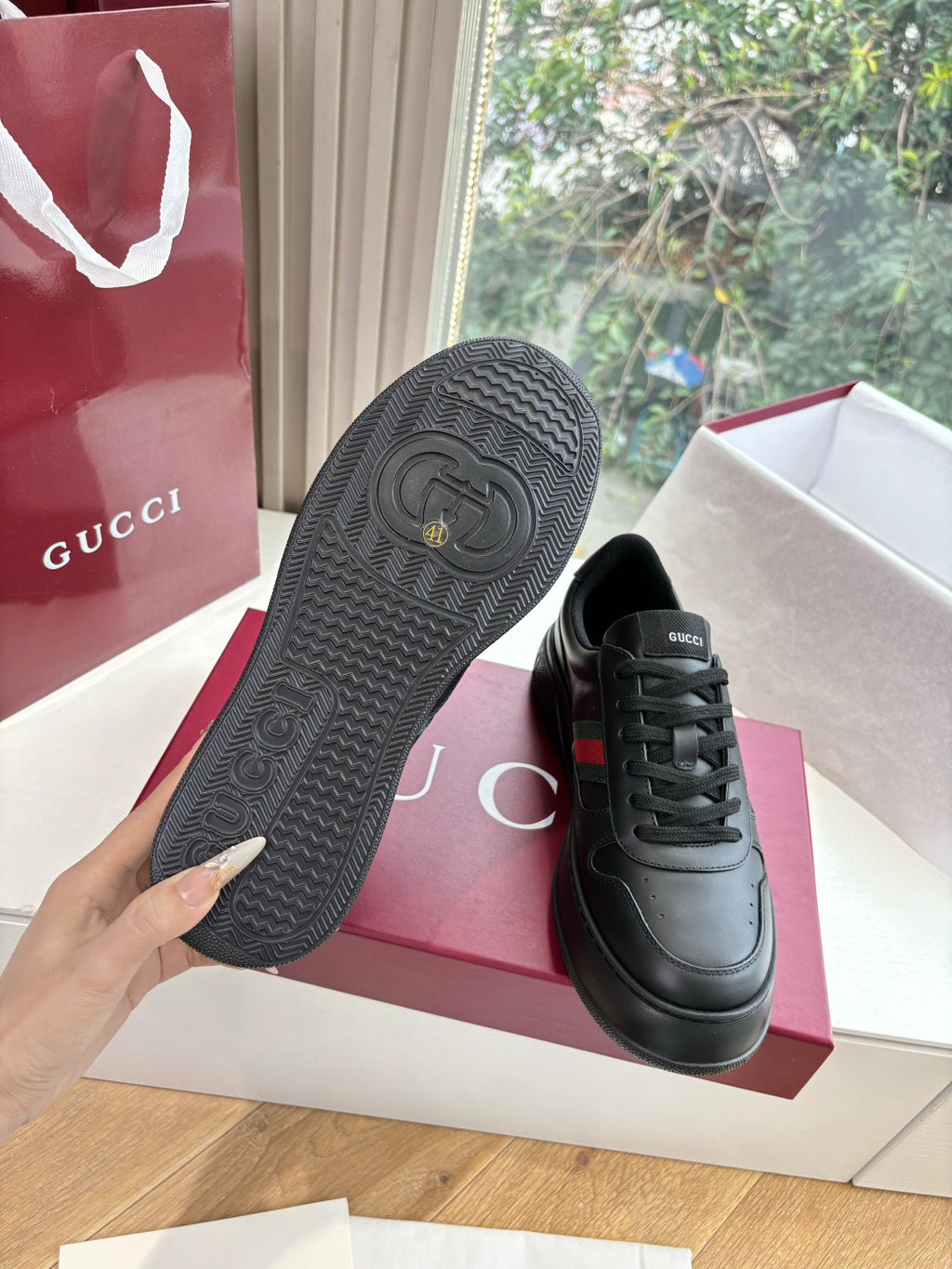 Gucci women's black leather sneakers, textured rubber outsole view
