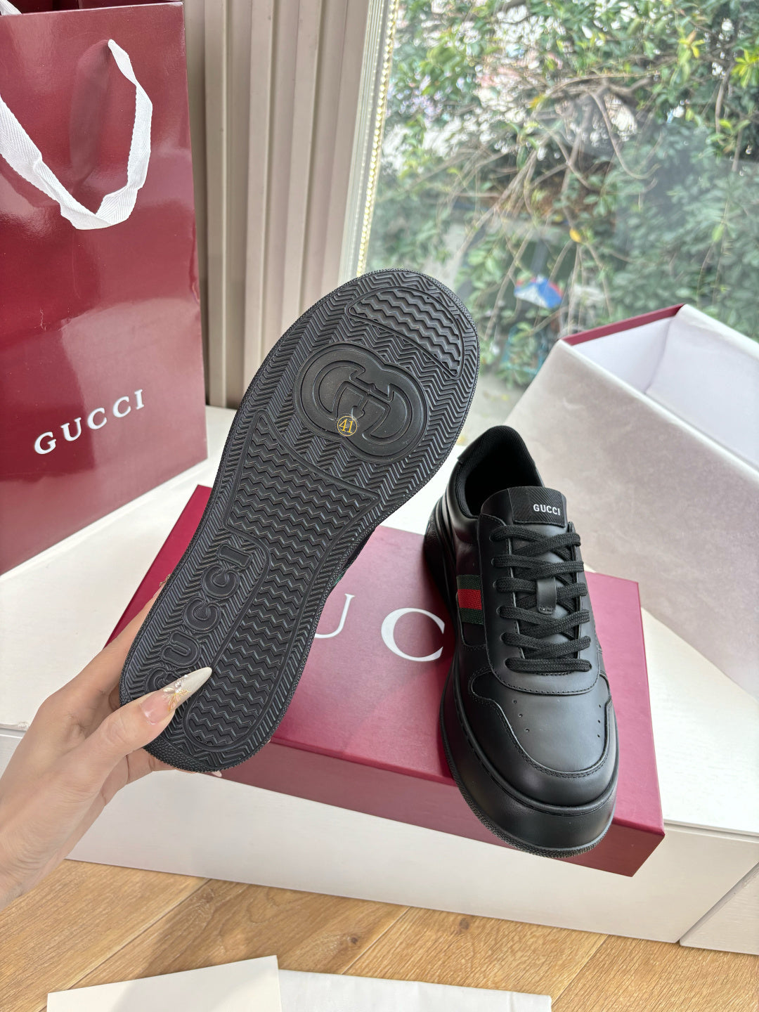 Gucci women's black leather sneakers, textured rubber outsole view
