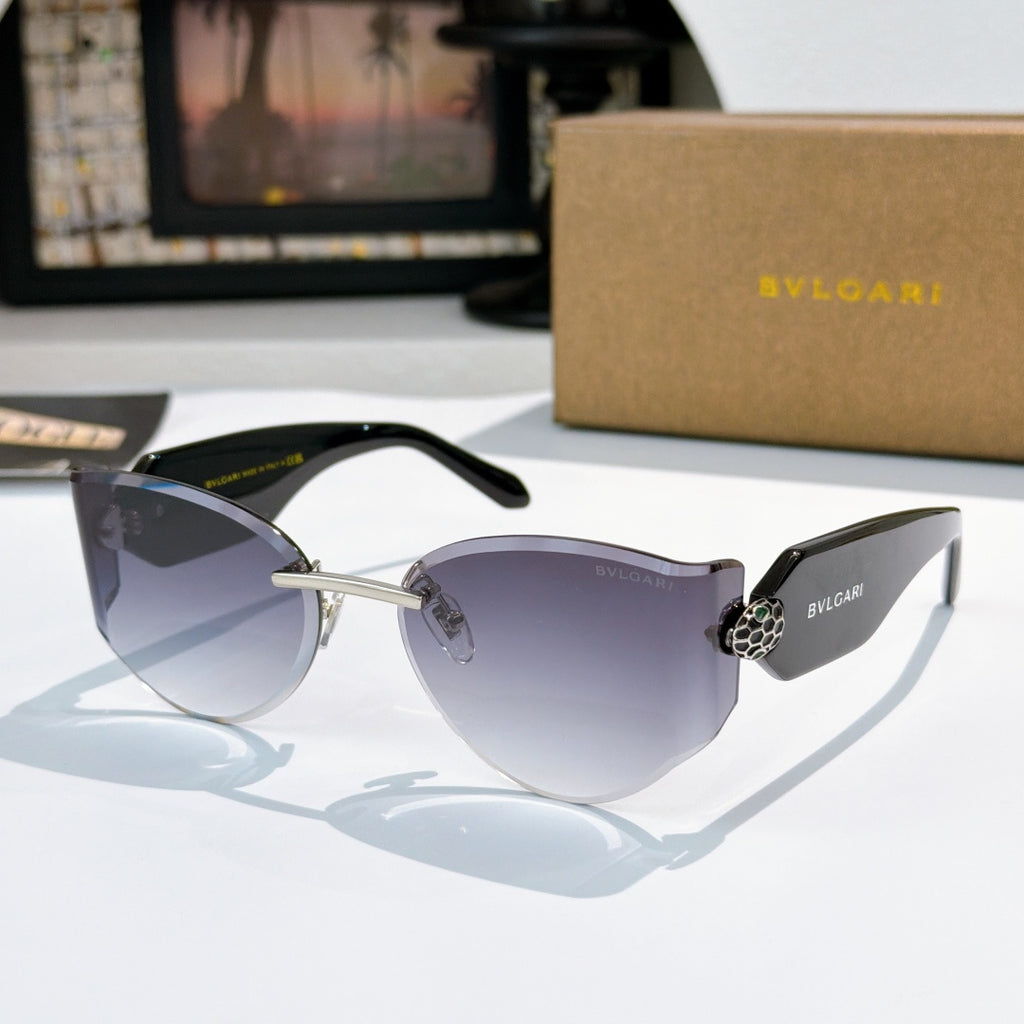 Bvlgari cat-eye sunglasses, black frame, dark purple gradient lenses, gold hinge emblem.