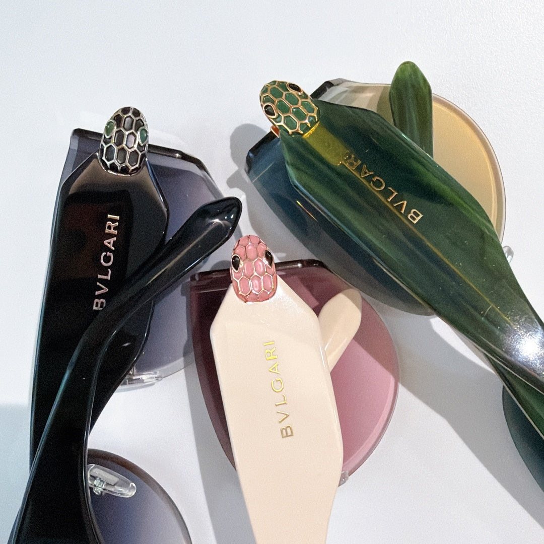 Bvlgari oversized sunglasses, dark lenses, green patterned emblem arms, gold hardware.
