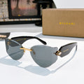 Bvlgari cat-eye sunglasses, dark gray lenses, gold frame with logo accents.