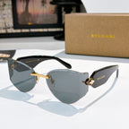 Bvlgari cat-eye sunglasses, dark gray lenses, gold frame with logo accents.