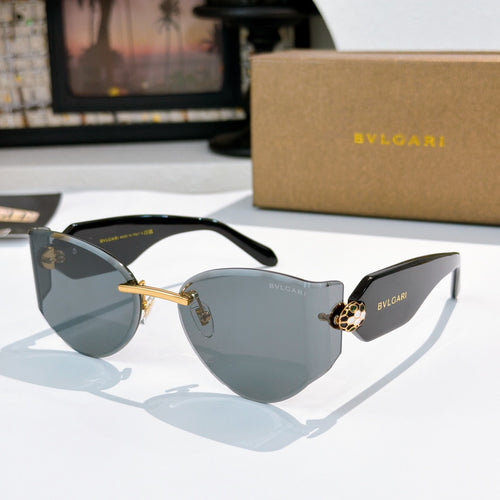 Bvlgari cat-eye sunglasses, dark gray lenses, gold frame with logo accents.