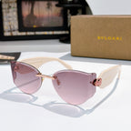 Bvlgari cat-eye sunglasses, pale pink frame, pink lenses, gold hinge emblem.