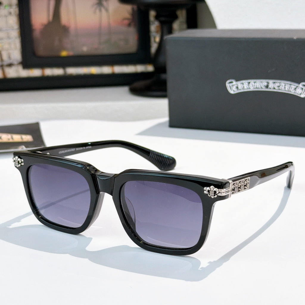 Sunglasses with purple-tinted lenses, black frame, and silver ornate temple details.