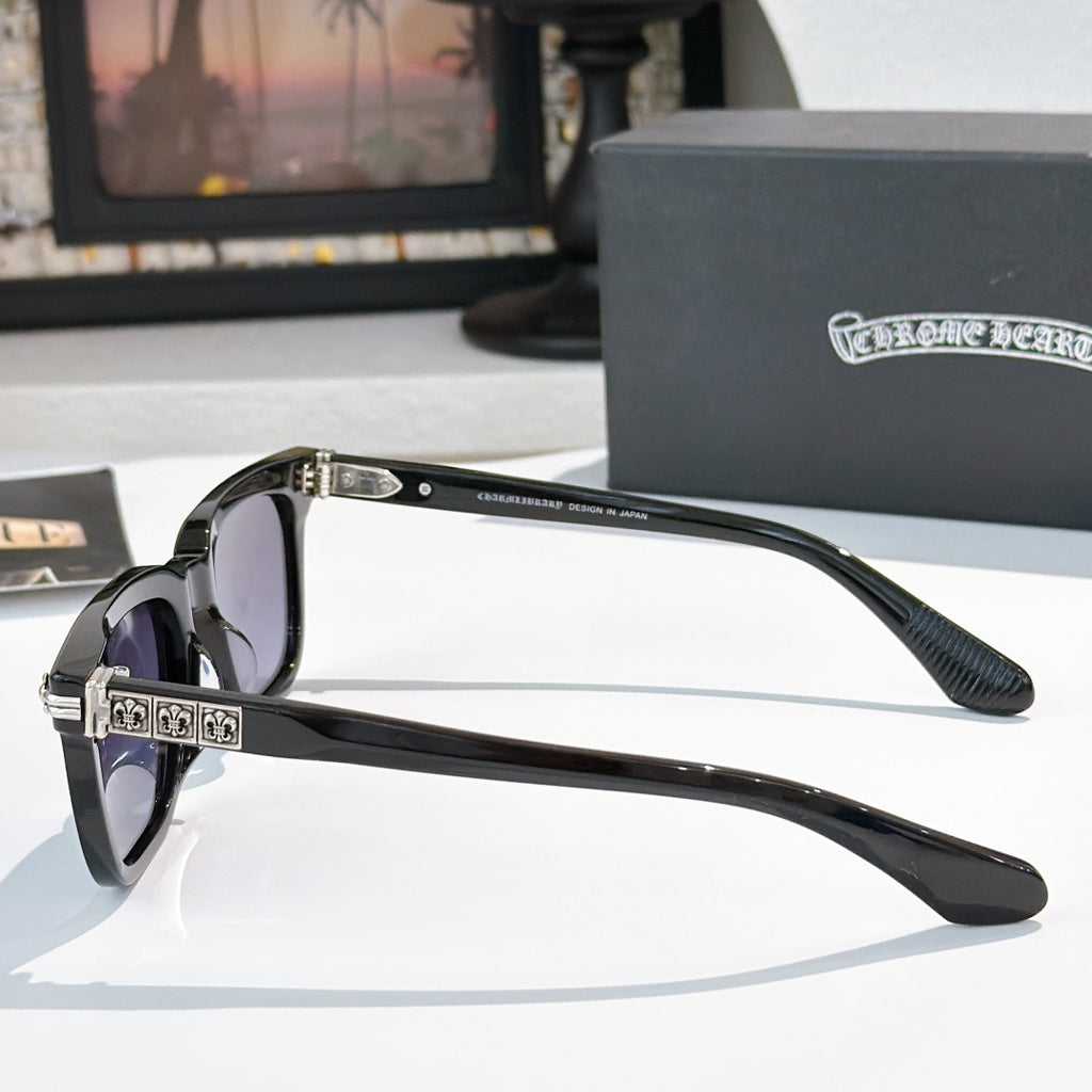 Sunglasses with gray lenses, black square frame, and silver ornate temple details.